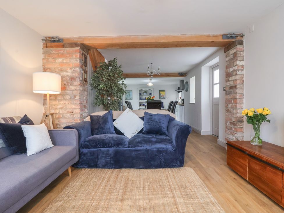 A living room with a sofa and lamp at The Old Vicarage Annex Hornsea