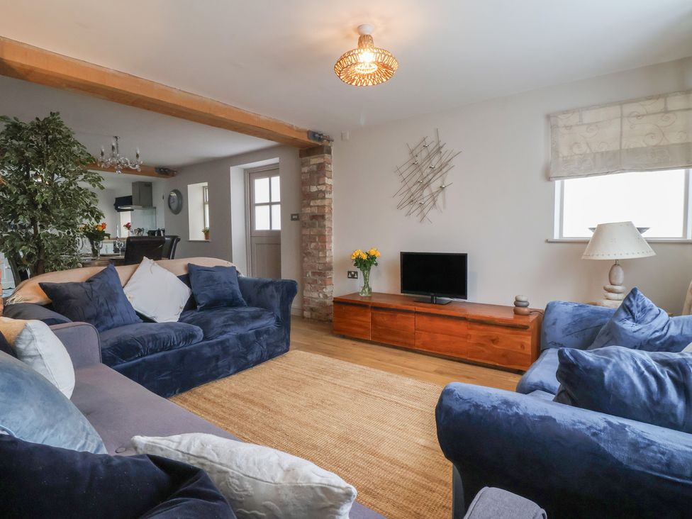 A living room with a television and seating area at The Old Vicarage Annex Hornsea