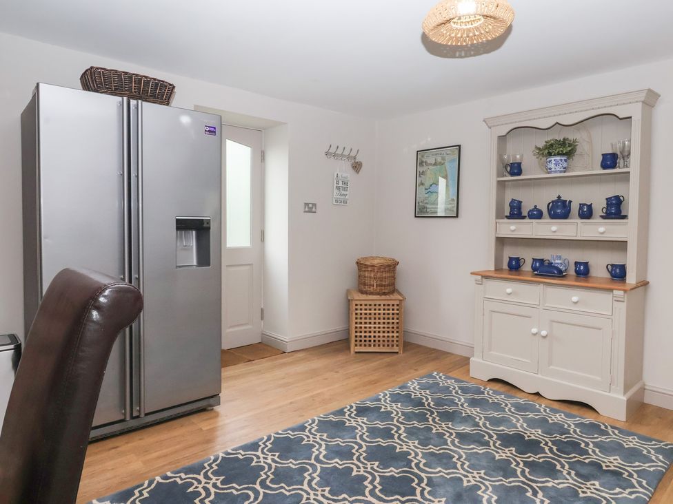 A kitchen with a refrigerator and shelving unit at The Old Vicarage Annex in Hornsea