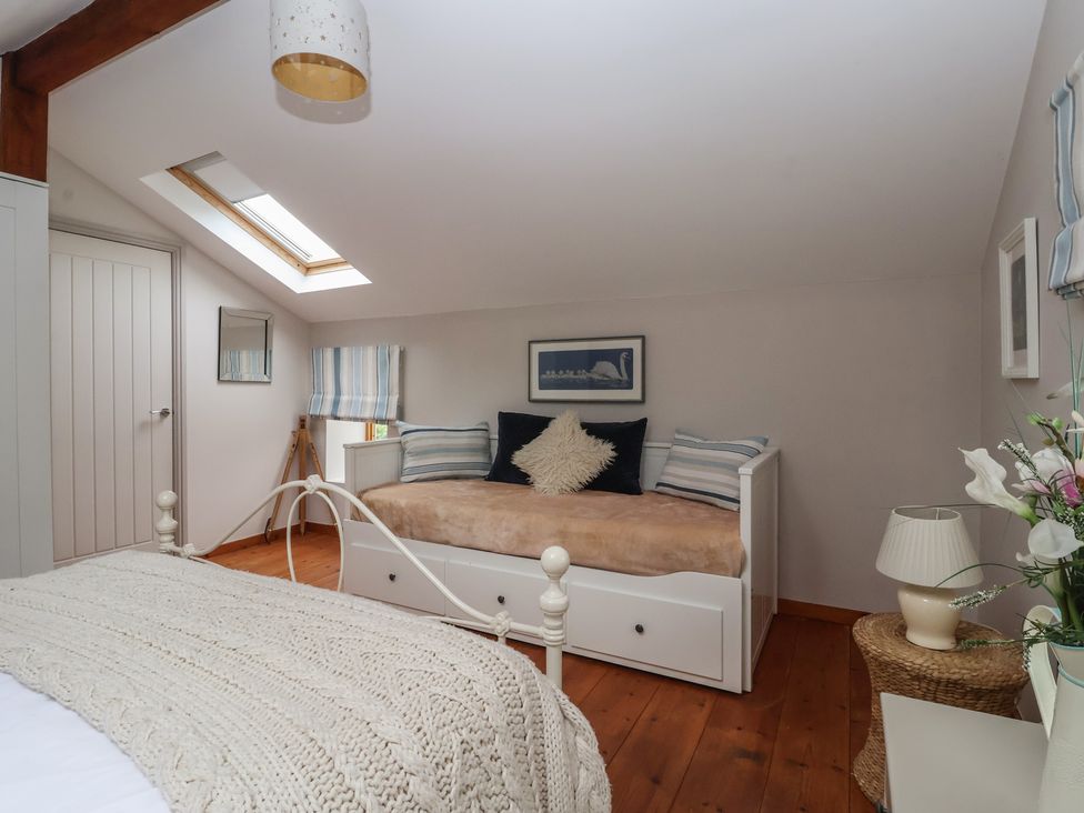 A bedroom with a bed and a sofa bed at The Old Vicarage Annex in Hornsea