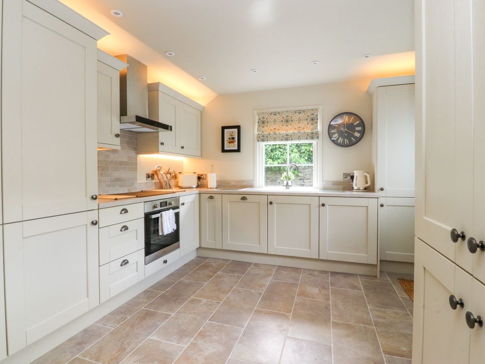 A kitchen with cabinets and a stove at Manor Lodge in Clitheroe