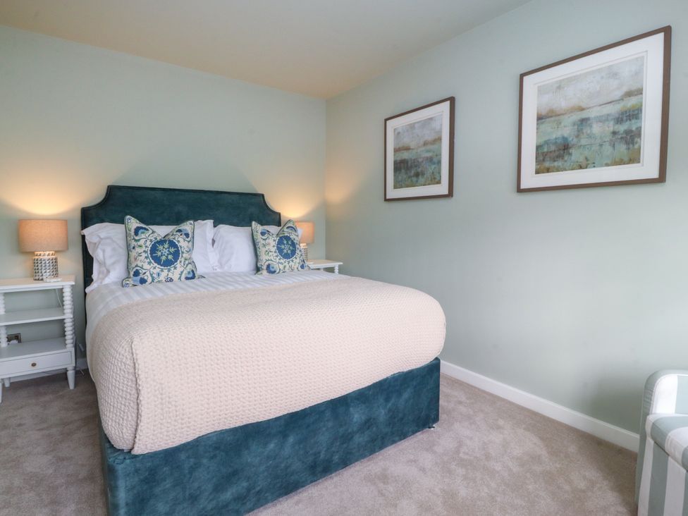 A bedroom with a bed and bedside tables at Manor Lodge Clitheroe