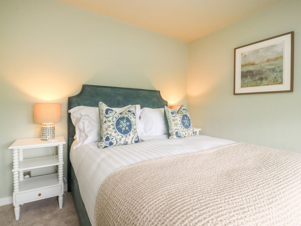 A bedroom with a bed and bedside table at Manor Lodge in Clitheroe