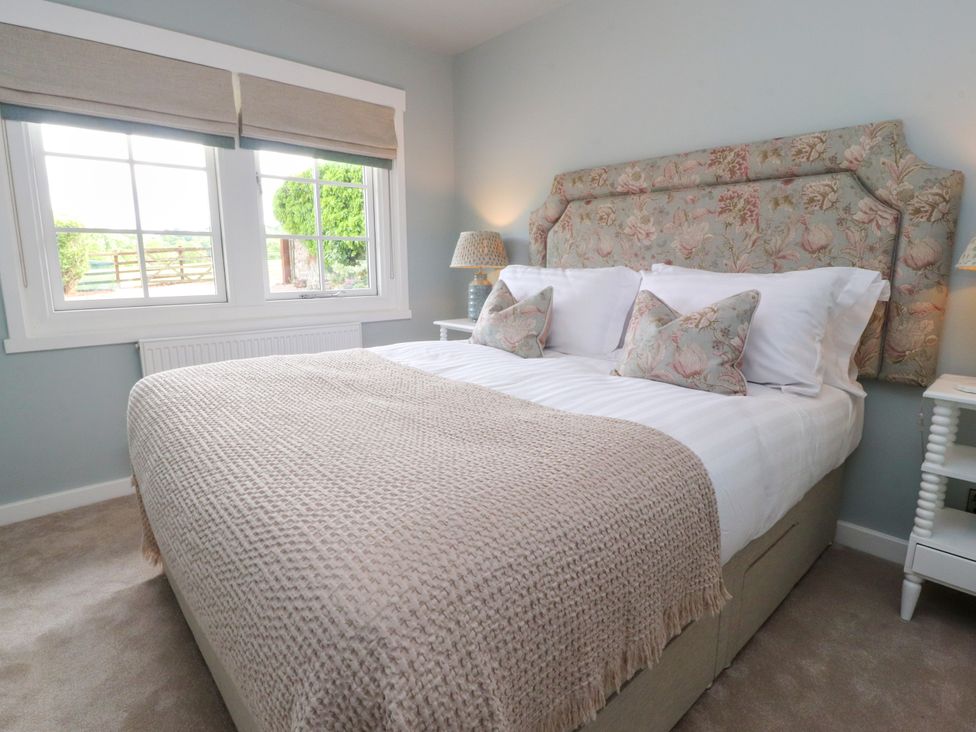 A bedroom with a bed and window at Manor Lodge in Clitheroe