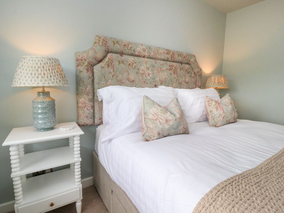 A bedroom with a bed and a bedside table at Manor Lodge Clitheroe
