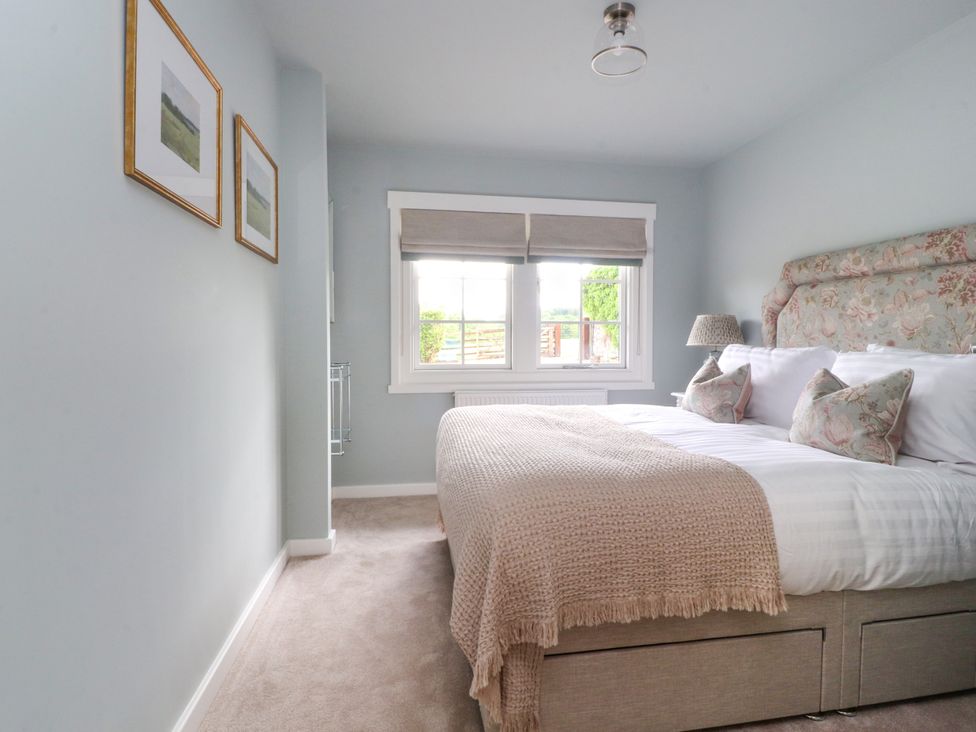 A bedroom with a bed and window at Manor Lodge in Clitheroe