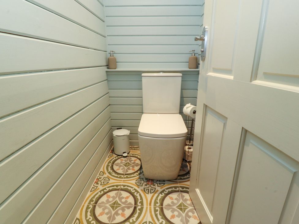 A bathroom with a toilet and hand sanitizer at Manor Lodge in Clitheroe