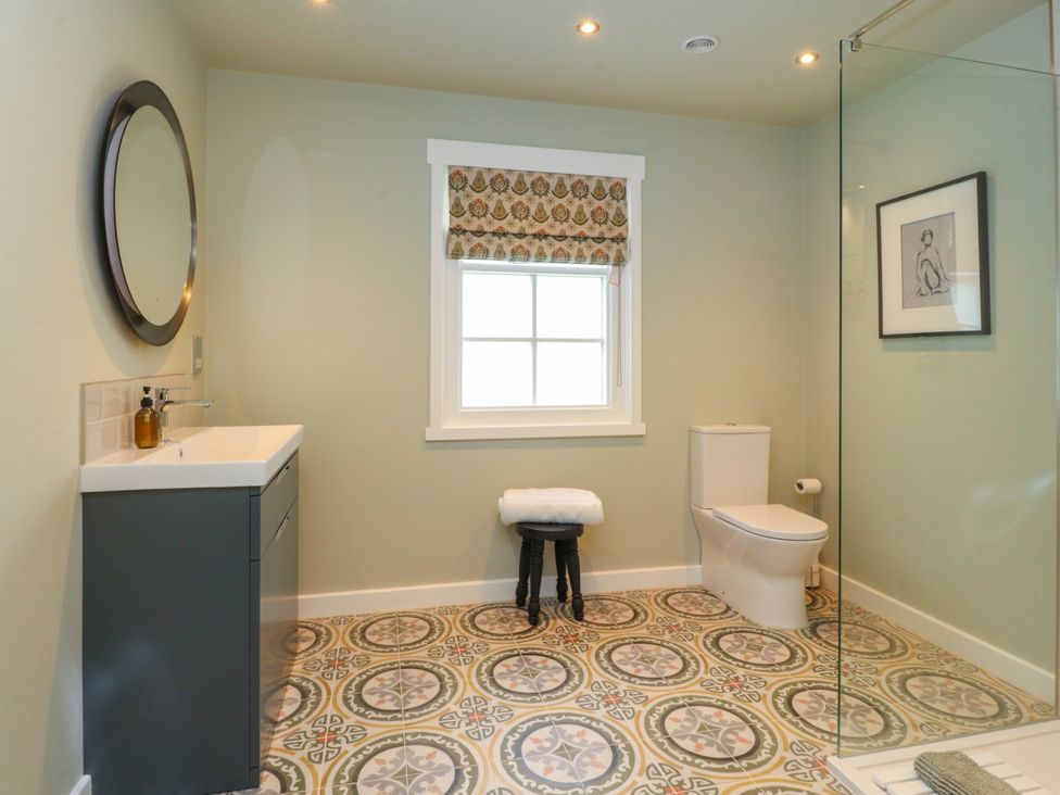 A bathroom with a sink, toilet, and shower at Manor Lodge in Clitheroe