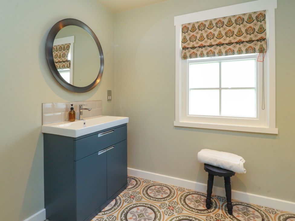 A bathroom with a sink and towel at Manor Lodge in Clitheroe