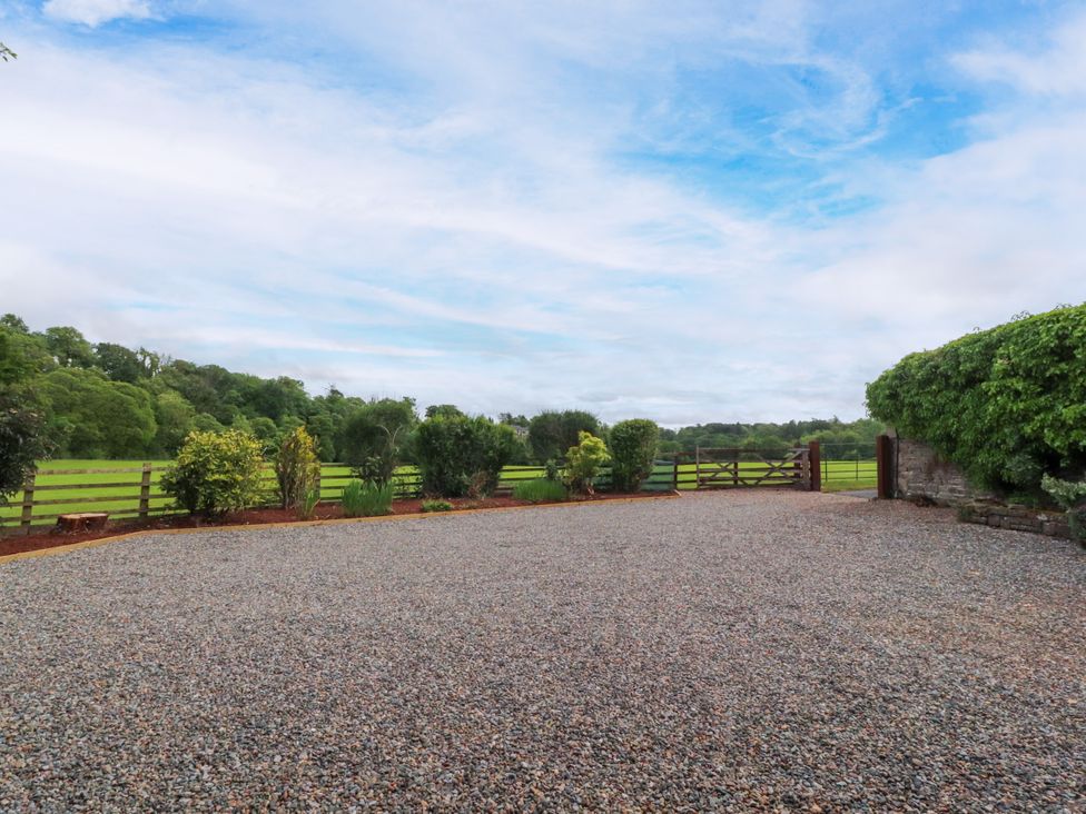 An outdoor area with gravel surface and a gate at Manor Lodge Clitheroe