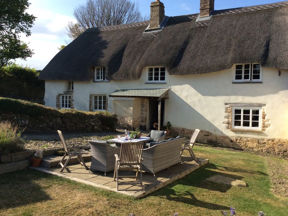 An outdoor patio area with furniture at Westacombe Farm in Dunsford near Tedburn St Mary