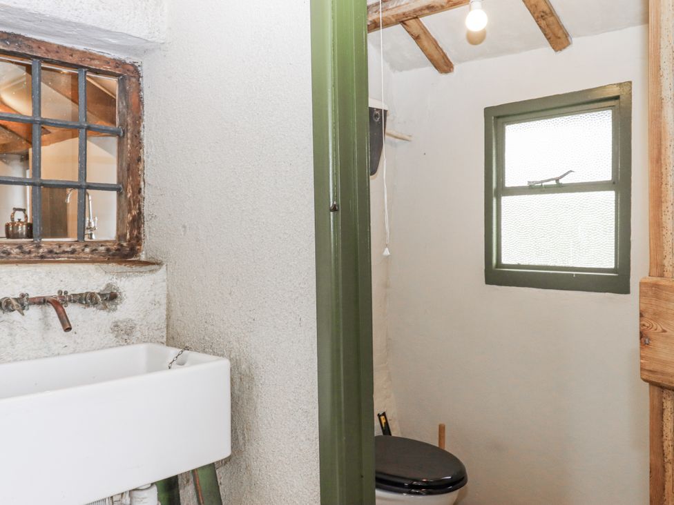 A bathroom with a toilet and a sink at Westacombe Farm in Dunsford
