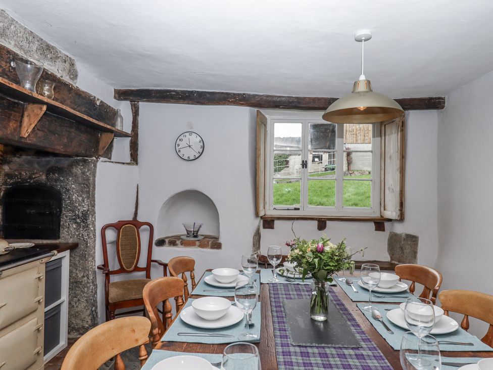 A dining room with a table set for a meal at Westacombe Farm in Dunsford