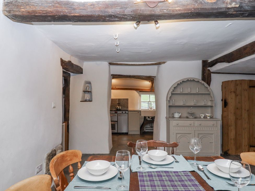 A dining room with a table set for dinner at Westacombe Farm in Dunsford