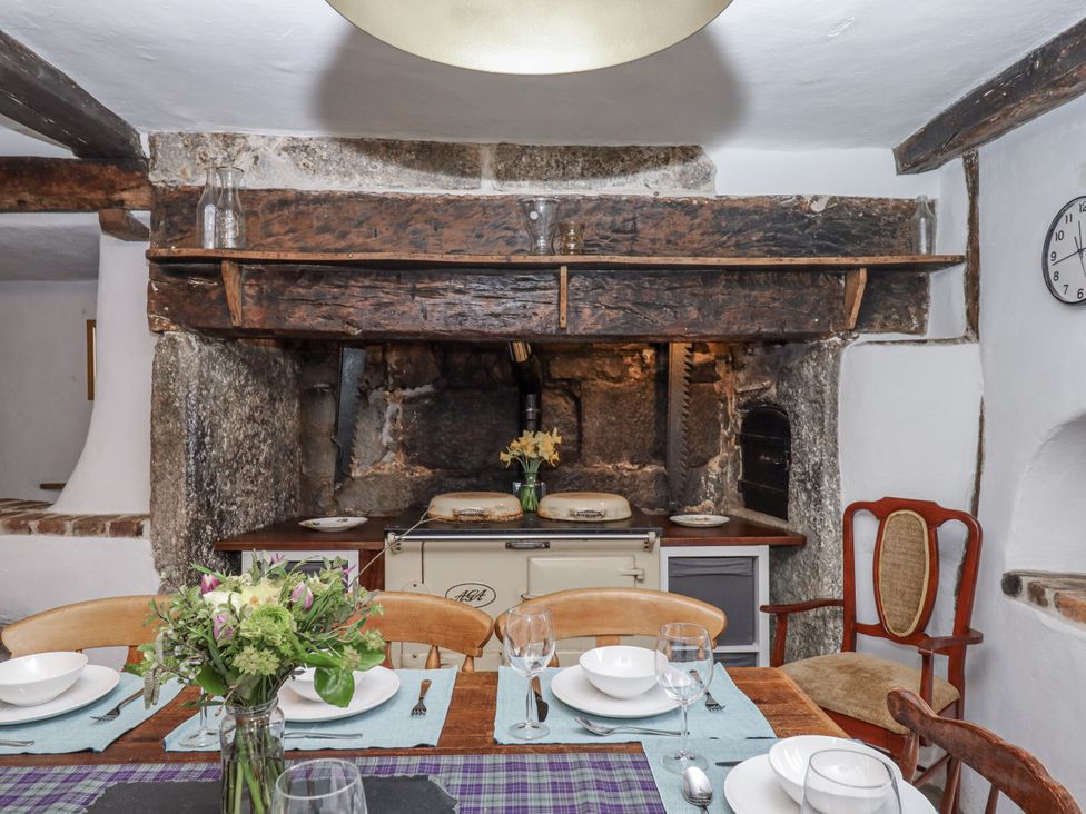 A kitchen with a dining table and a range cooker at Westacombe Farm in Dunsford