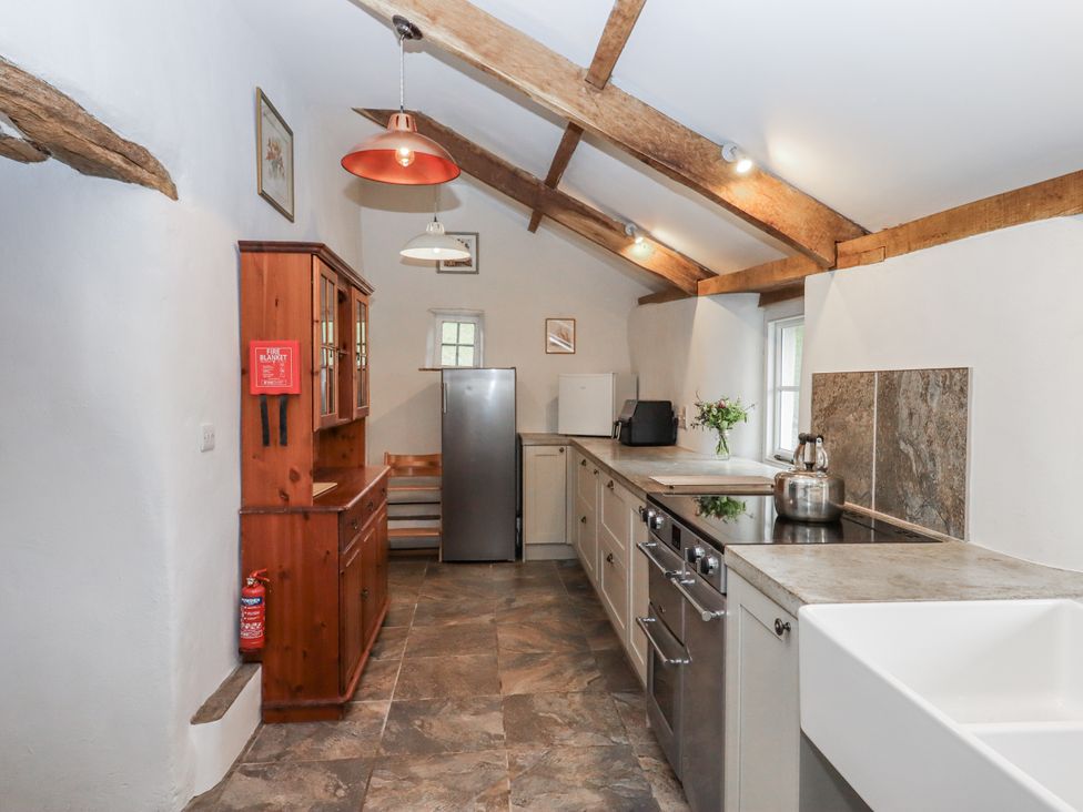 A kitchen with a refrigerator, sink, and oven at Westacombe Farm Dunsford