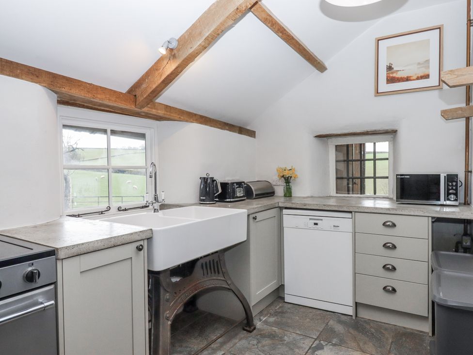 A kitchen with a sink and appliances at Westacombe Farm in Dunsford