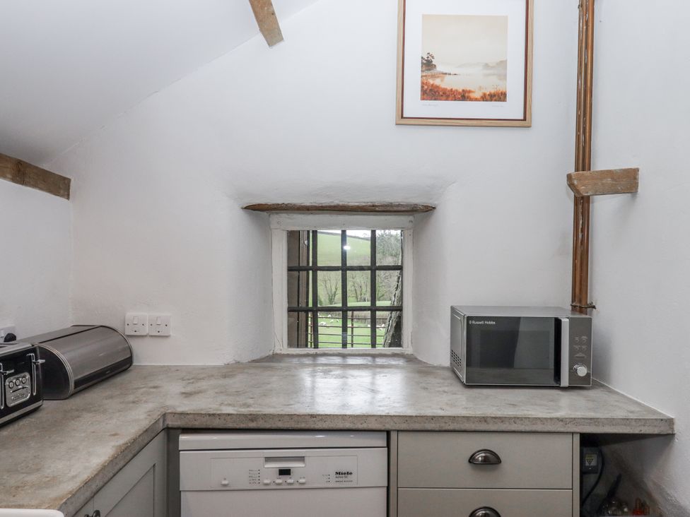 A kitchen with a window and appliances at Westacombe Farm in Dunsford