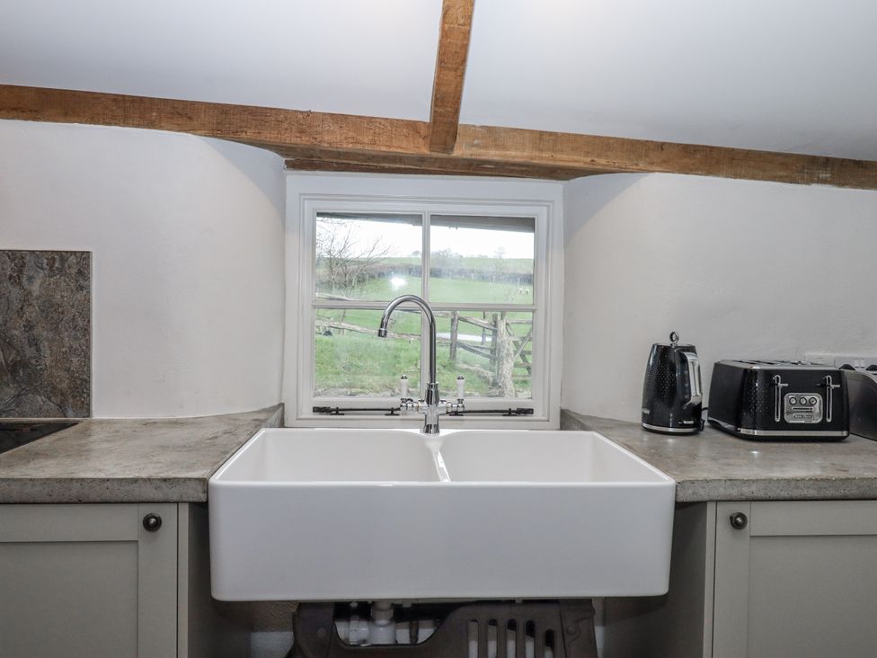 A kitchen with a sink and window at Westacombe Farm in Dunsford