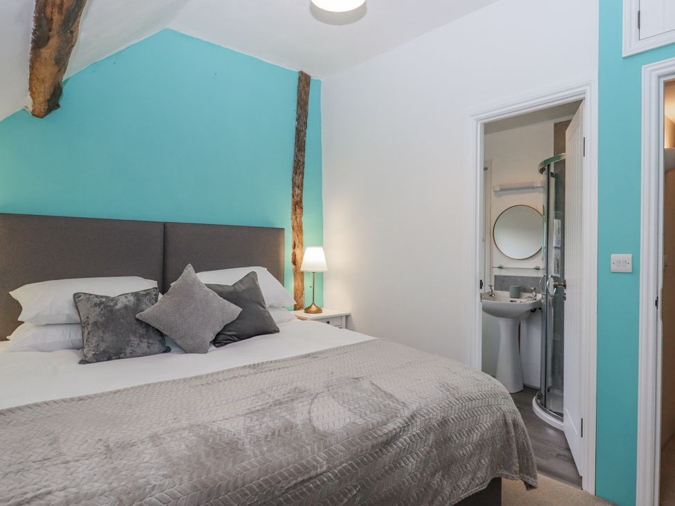 A bedroom with a bed and en-suite bathroom at Westacombe Farm in Dunsford