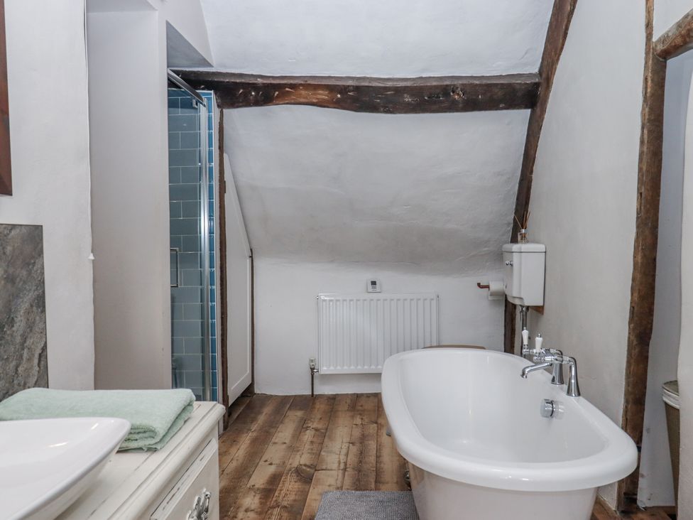 A bathroom with a bathtub and shower at Westacombe Farm in Dunsford