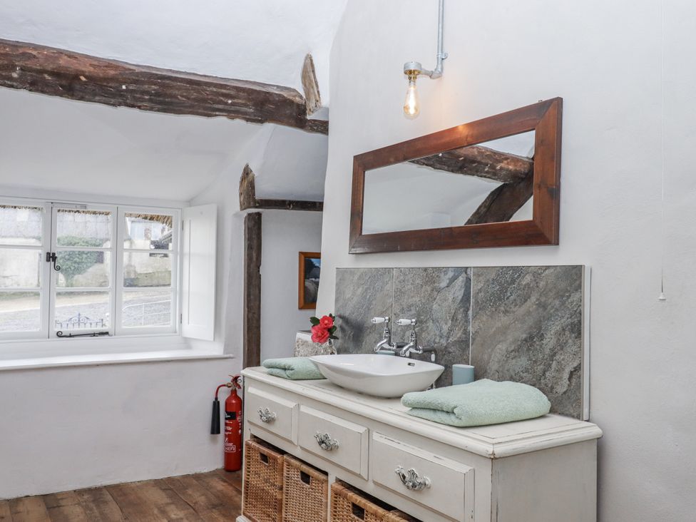 A bathroom with a sink and mirror at Westacombe Farm in Dunsford