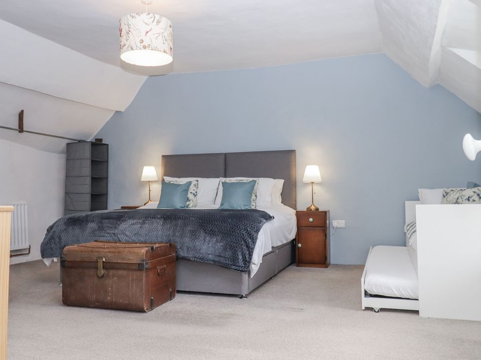 A bedroom with a bed and bedside table at Westacombe Farm in Dunsford
