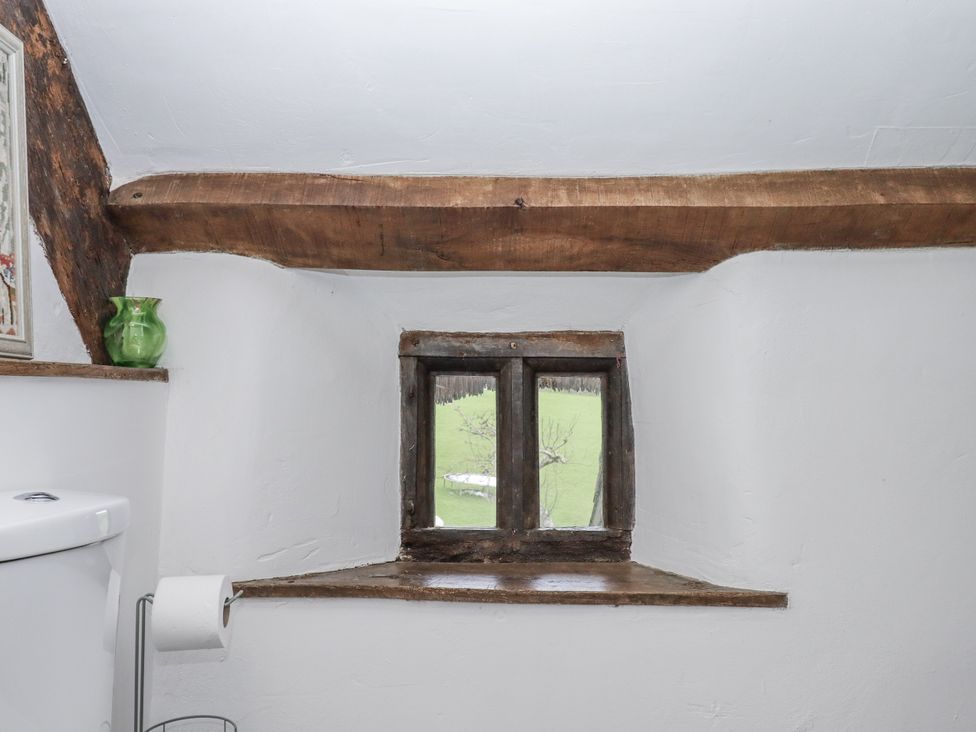 A bathroom with a window and a toilet at Westacombe Farm in Dunsford
