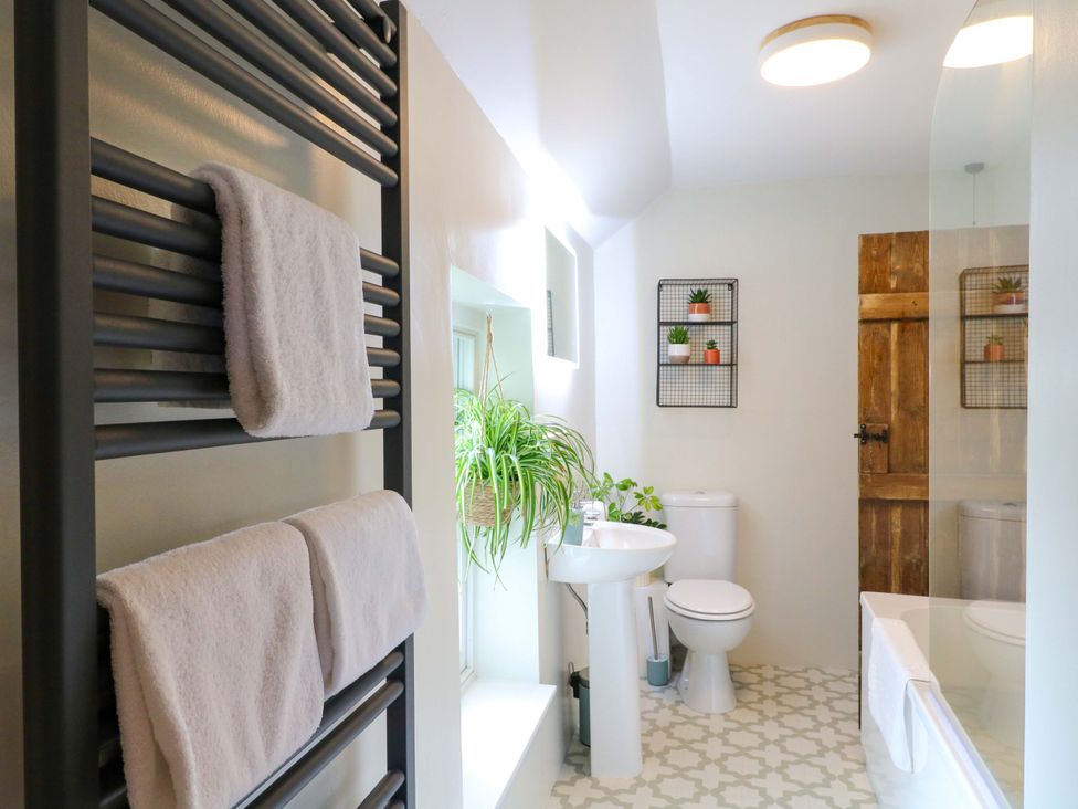 A bathroom with a towel radiator and a shower at Chimney Cottage in Winster