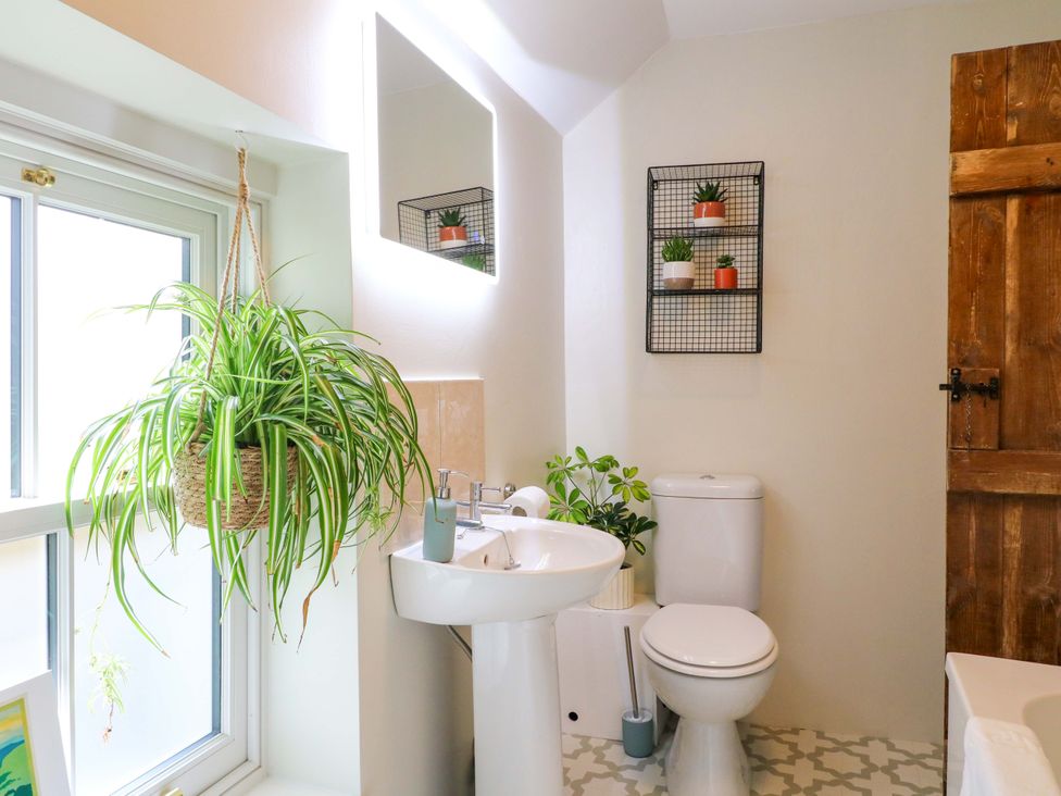 A bathroom with a sink and toilet at Chimney Cottage in Winster