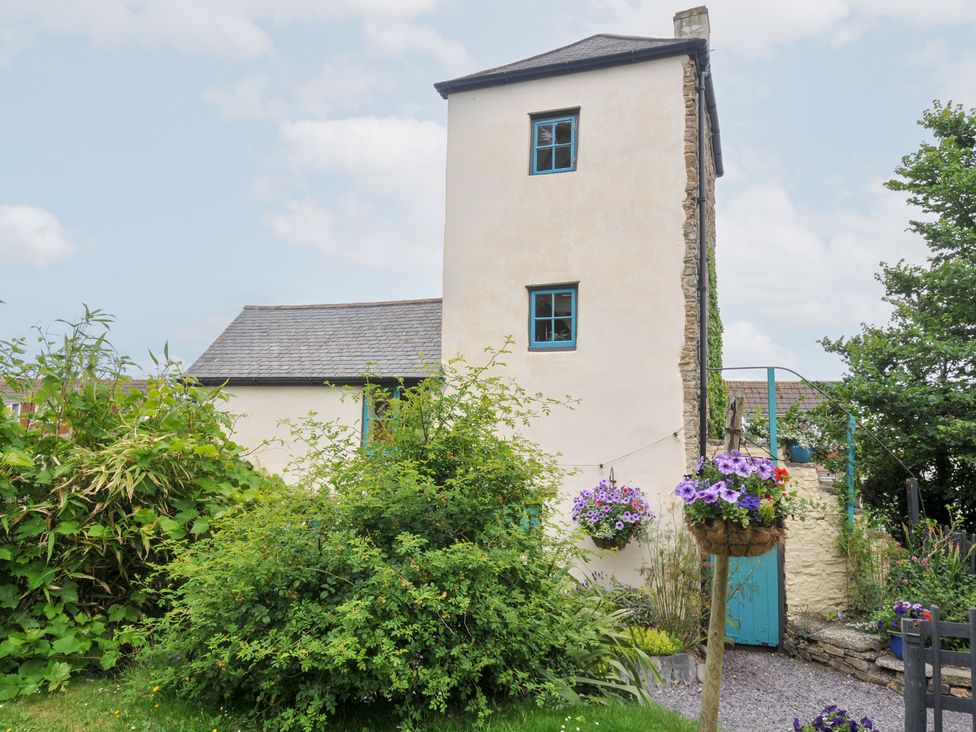 An outdoor view of a building with a blue door and flower arrangements at Tadworthy Tower in Northam