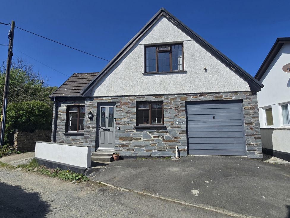 A house with a garage and landscaped area at Kernyk in Camelford