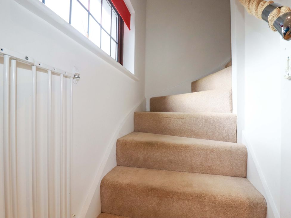 A staircase with carpet and a radiator at Kernyk in Camelford