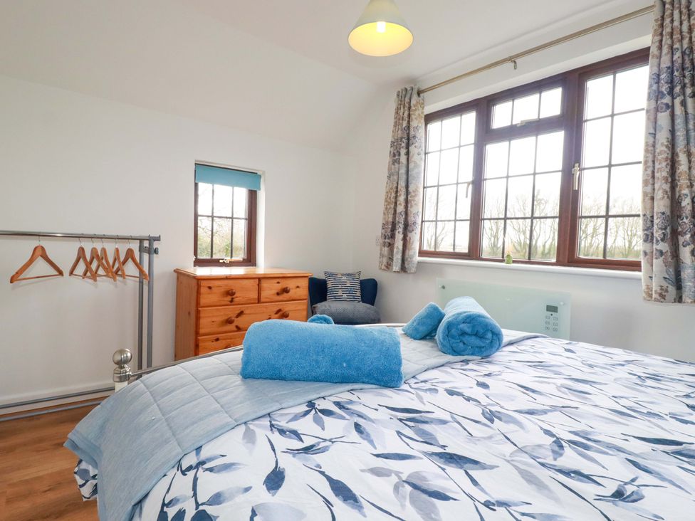 A bedroom with a bed and a dresser at Kernyk in Camelford
