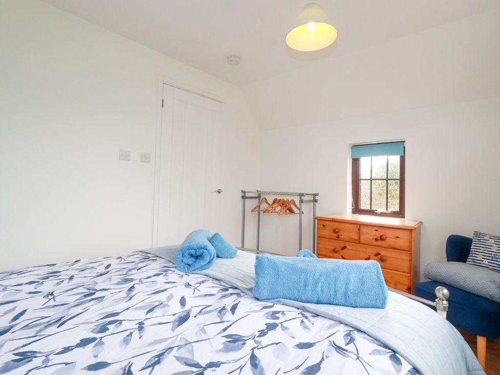 A bedroom with a bed and dresser at Kernyk in Camelford