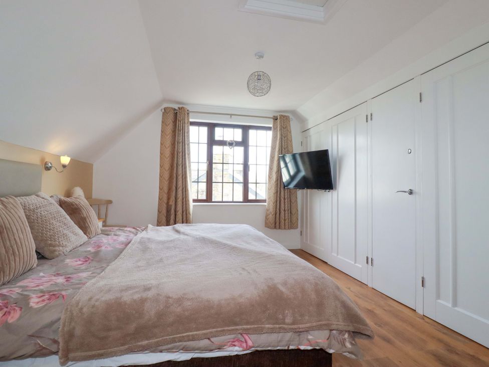 A bedroom with a bed and a television at Kernyk in Camelford