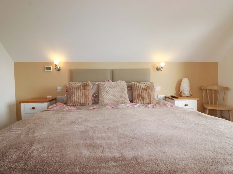 A bedroom with a bed and bedside table at Kernyk in Camelford