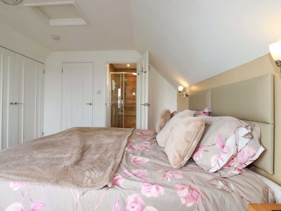 A bedroom with a bed and wardrobe at Kernyk in Camelford