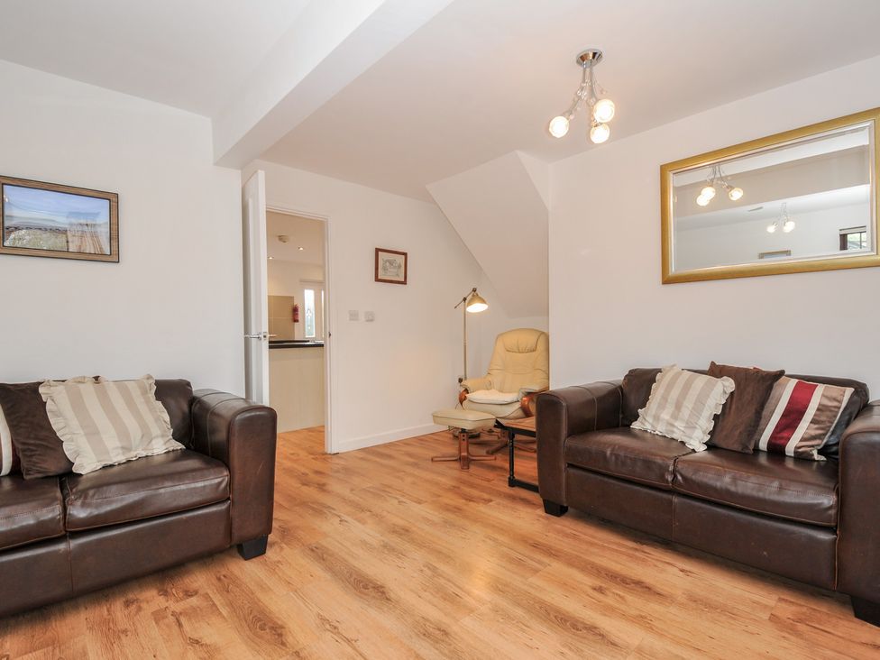 A living room with sofas and an armchair at Kernyk Camelford