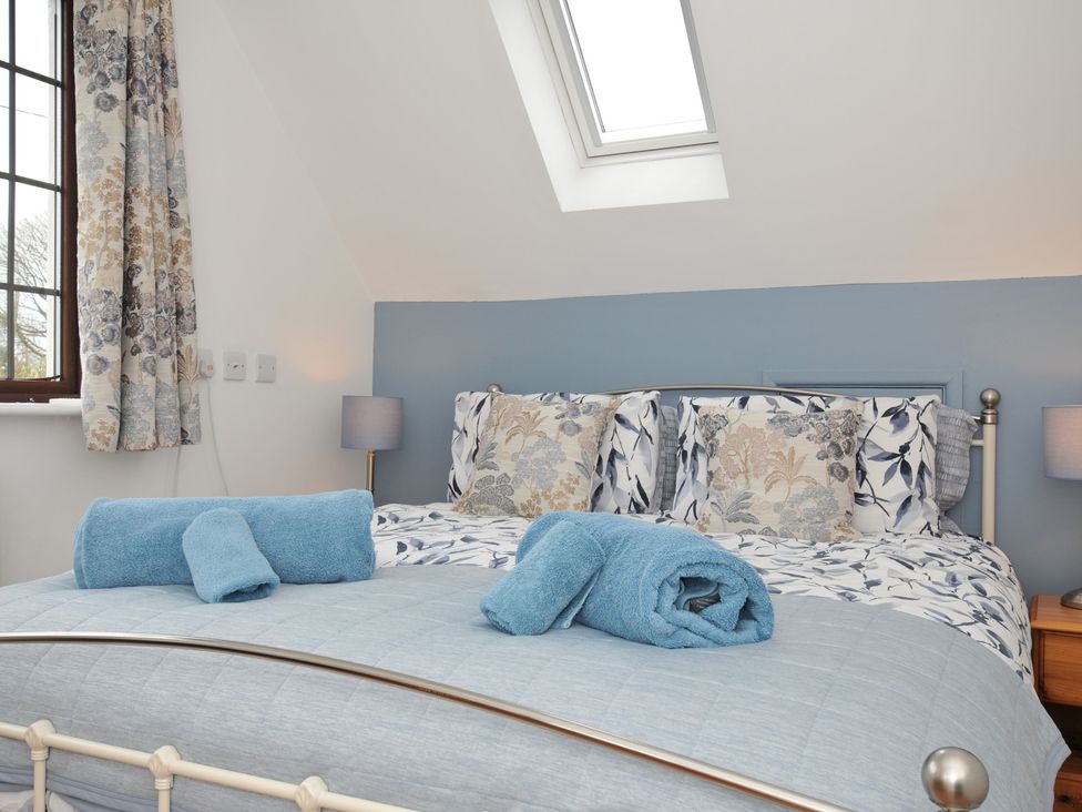 A bedroom with a bed and pillows at Kernyk in Camelford
