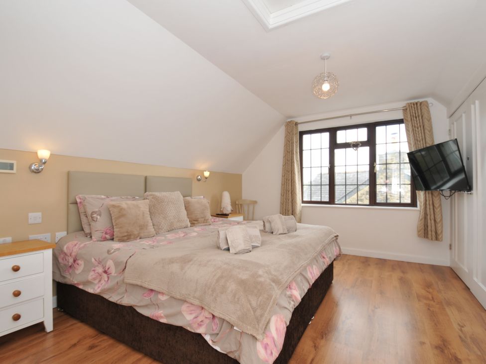 A bedroom with a bed and television at Kernyk in Camelford