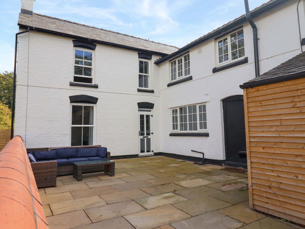 An outdoor area with a patio and sofa at The Farmhouse in Oswestry