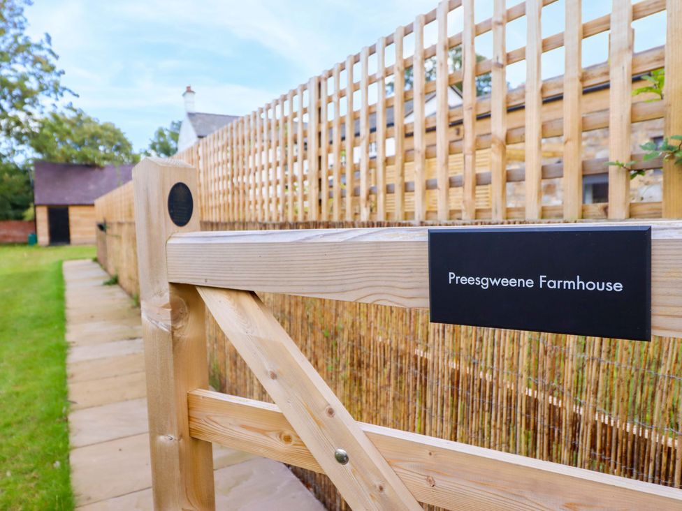 A gate leading to Preesgweene Farmhouse with a pathway in Oswestry