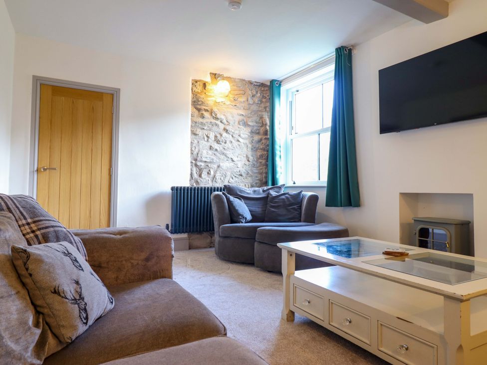 A living room with a sofa and coffee table at The Farmhouse in Oswestry