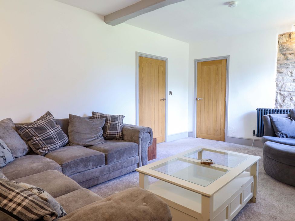A living room with a sofa and coffee table at The Farmhouse in Oswestry
