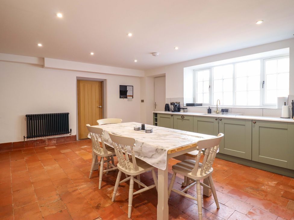 A kitchen with a table and chairs at The Farmhouse in Oswestry