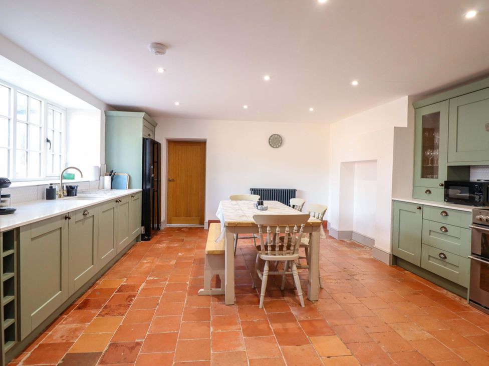 A kitchen with a table and chairs at The Farmhouse in Oswestry