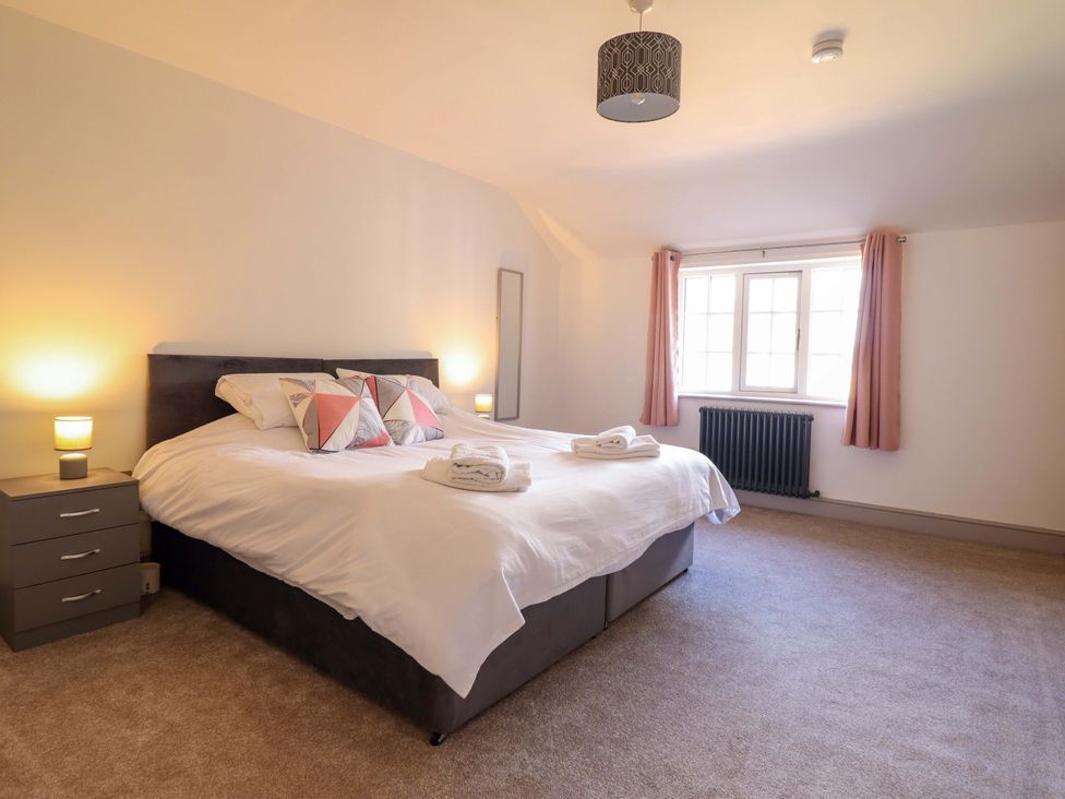 A bedroom with a bed and bedside table at The Farmhouse in Oswestry