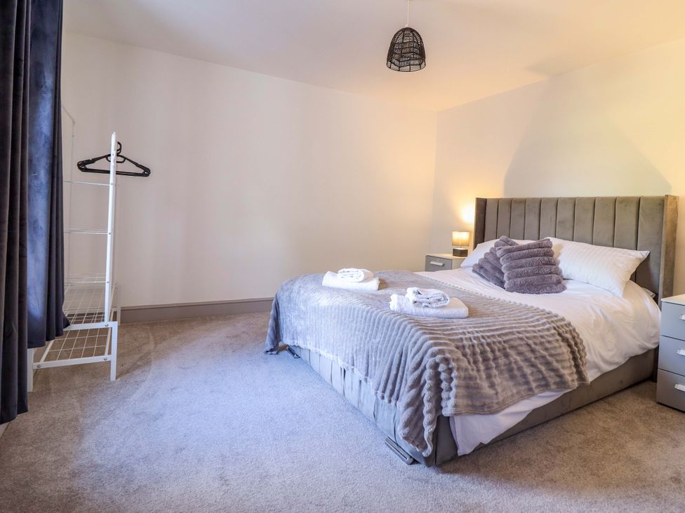 A bedroom with a bed and nightstand at The Farmhouse in Oswestry