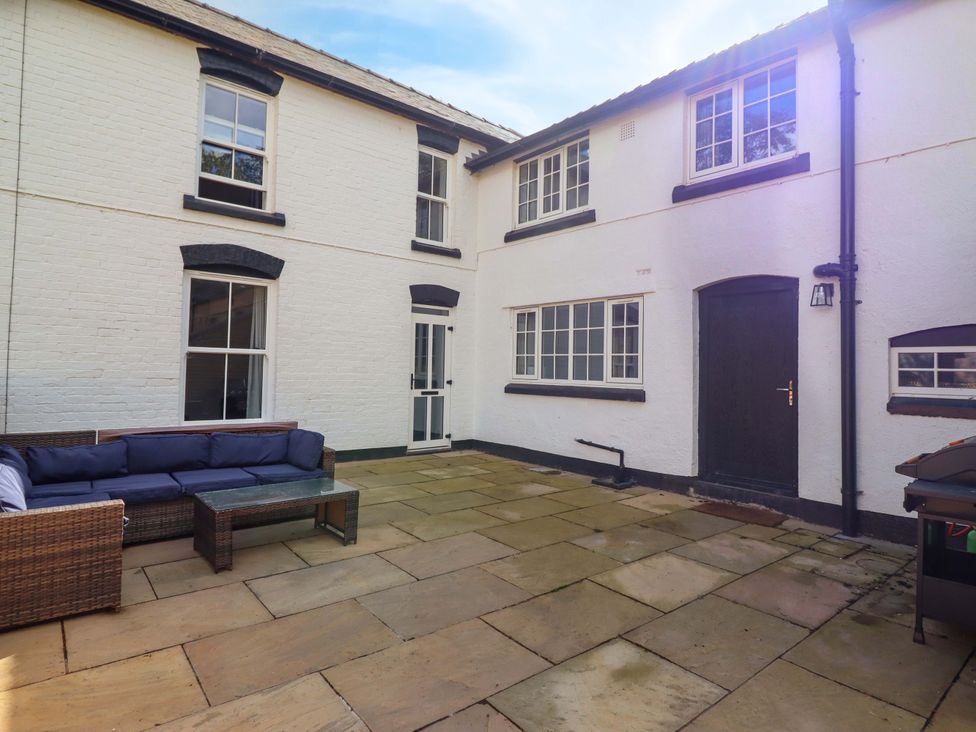 An outdoor area featuring a couch and coffee table at The Farmhouse in Oswestry